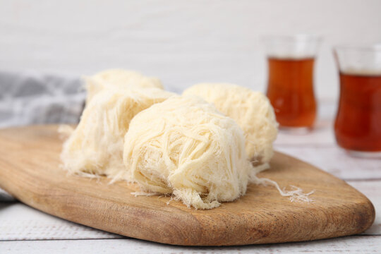 Eastern sweets. Tasty Iranian pashmak on white wooden table, closeup