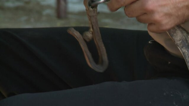 An Argentine Gaucho Repairing Horse Bridles in his Country House. Close Up.