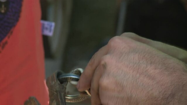 An Argentine Gaucho Repairing Horse Bridles in his Country House. Close Up.