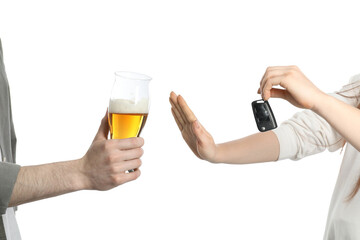 Woman with car keys refusing alcohol while man suggesting her beer on white background, closeup....