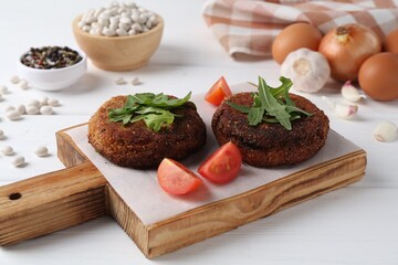 Vegetarian product. Tasty bean cutlets served on white wooden table