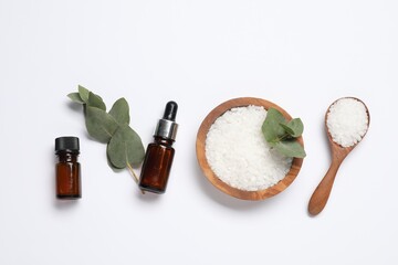 Aromatherapy products. Bottles of essential oil, sea salt and eucalyptus leaves on white...