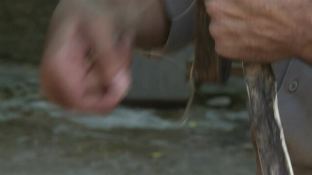 An Argentine Gaucho Repairing Horse Bridles in his Country House. Close Up.