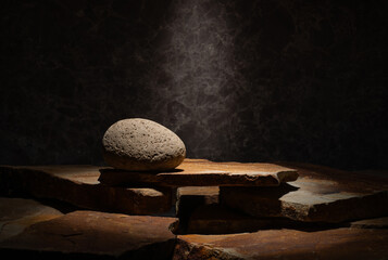 stones with texture on a dark background for a product presentation podium