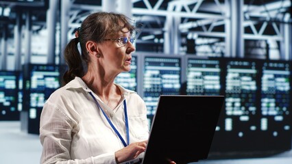 Adept computer scientist looking around cutting edge data center, preparing to start comission on...