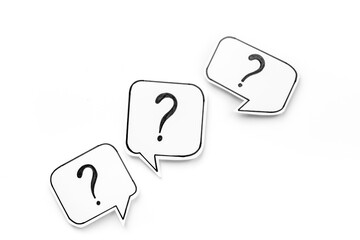 FAQ concept - paper speech bubbles with question mark, top view