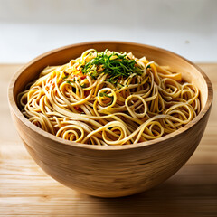 A wooden bowl filled with spaghetti, topped with green herbs, placed on a table. - obrazy, fototapety, plakaty
