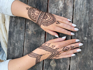Exquisite henna tattoo on hands with intricate mandala and geometric patterns, ideal for cultural...
