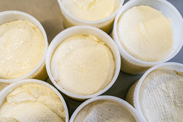 Close-up of filled molds for the production of mozzarella cheese. Selected focus