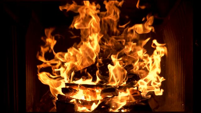 Beautiful shot of camp and fireplace fire burning in the dark at night.