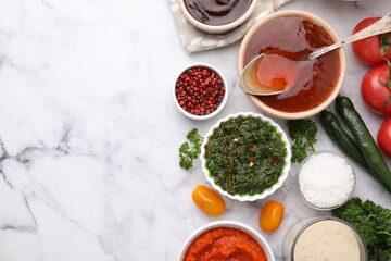 Different marinades and products on white marble table, flat lay. Space for text