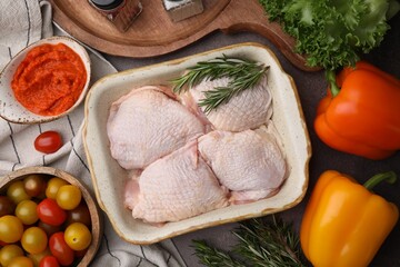 Flat lay composition with marinade, raw chicken, rosemary and other products on table © New Africa