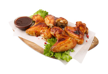 Board with marinade, chicken wings, spices and lettuce isolated on white