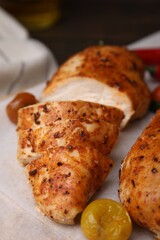 Baked marinated chicken fillets on table, closeup