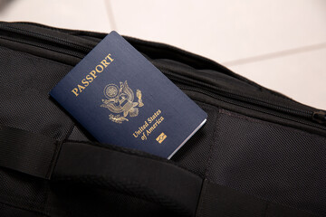 Close up of an American passport in a black travel bag pocket