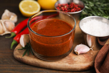 Fresh marinade and ingredients on wooden table, closeup