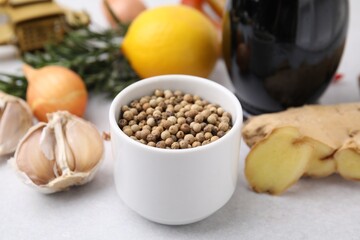 Aromatic peppercorns and different fresh ingredients for marinade on light grey table