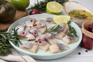 Tasty marinated fish with rosemary and spices on light table, closeup