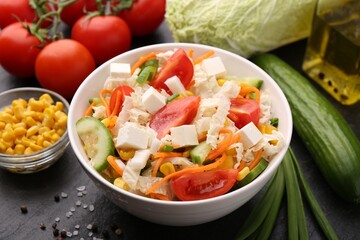 Tasty salad with Chinese cabbage served on black table