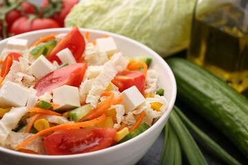 Tasty salad with Chinese cabbage, carrot, cheese, cucumber and tomato on table, closeup