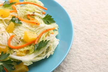 Tasty salad with Chinese cabbage on beige textured table, closeup. Space for text
