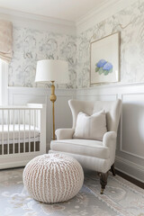A baby nursery with light grey wallpaper, vintage furniture, and an oversized knitted ottoman, featuring soft pastel tones and elegant wall art patterns.