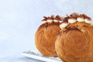 Tasty puff pastry. Supreme croissants with chocolate chips and cream on grey background, closeup. Space for text