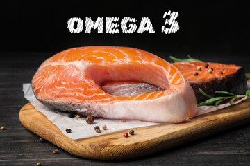 Omega 3. Board with fresh salmon steaks and peppercorns on black wooden table, closeup