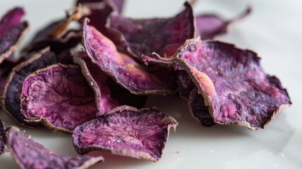 Fototapeta premium Several dehydrated purple sweet potatoes on a white surface
