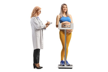 Doctor checking weight of a pregnant woman