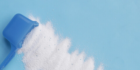 Detergent powder with measuring spoon. Laundry concept.