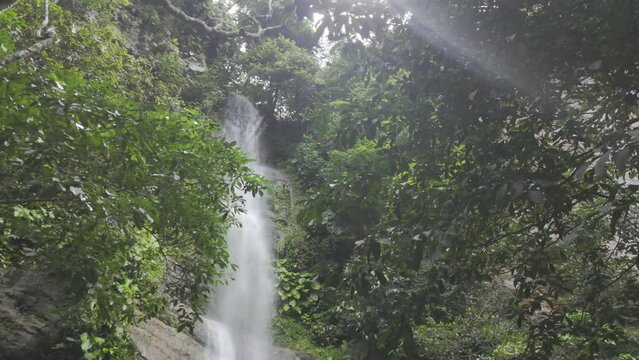 Drone hovers as camera pans from top of Cachoeira Escorrega Macaco down to the bottom