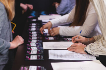 Process of checking in on a conference congress forum event, registration desk table, visitors and...