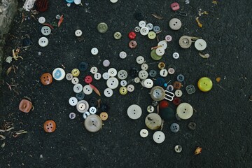 Colored beads and buttons on the ground 