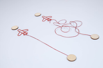 Legs in white sneakers in front of straight and tangled arrows