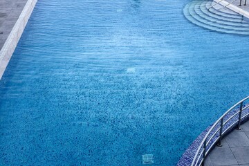 Clean beautiful outdoor pool in a prestigious hotel in a seaside resort. There is sea wave summer...