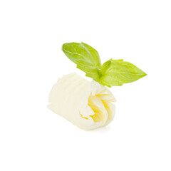 Tasty butter curl and basil leaves isolated on white