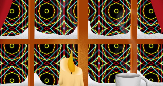 A cat sitting by mug, looking out a window with a colorful geometric pattern