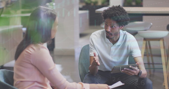 Diverse couple is discussing, man holding tablet