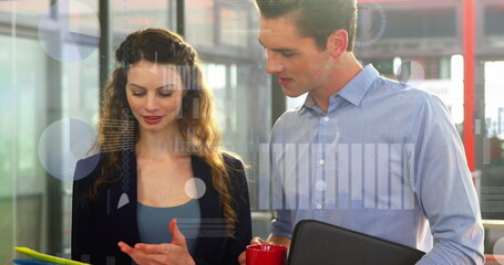 Caucasian chef and assistant looking at tablet, holding files and cup