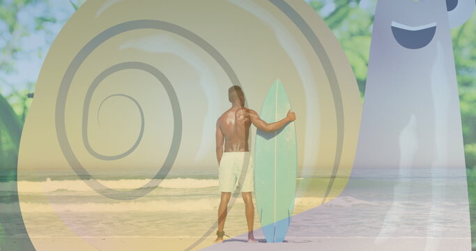 African American male holding surfboard on beach