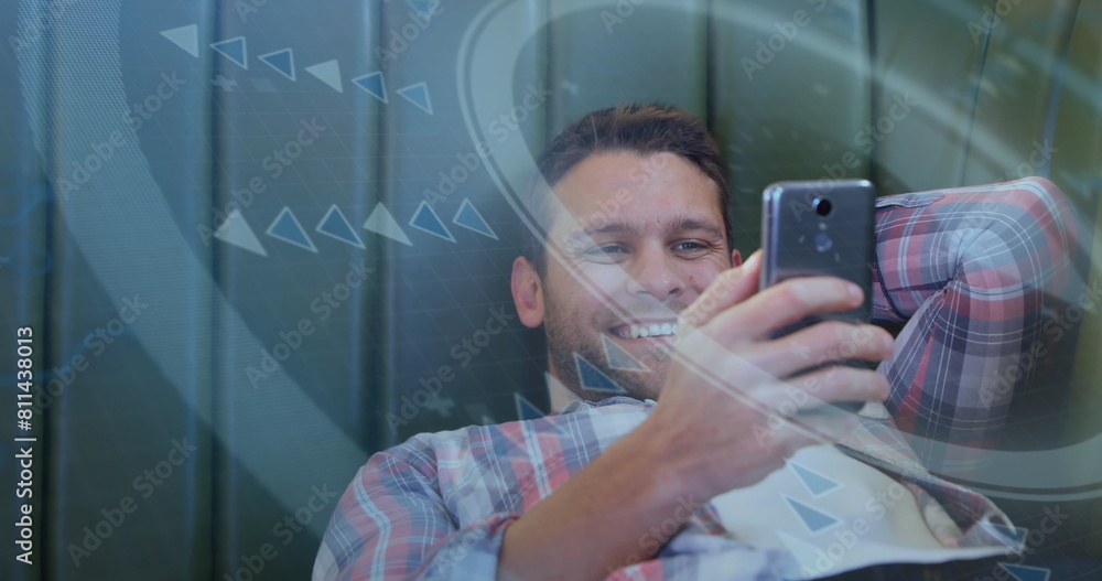 Poster image of round scanner against caucasian man smiling while using a smartphone