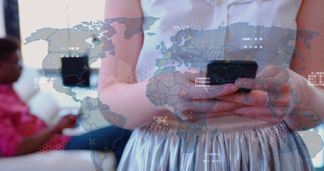 Image of world map against mid section of caucasian woman using smartphone at office - Powered by Adobe