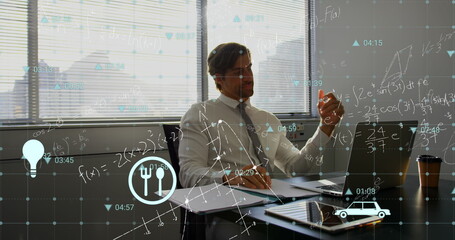 Image of multiple icons, mathematical equation and diagrams, caucasian man working on laptop