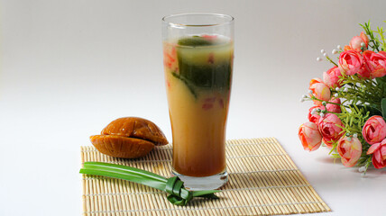 a glass of grass jelly ice with brown sugar. typical Indonesian drink