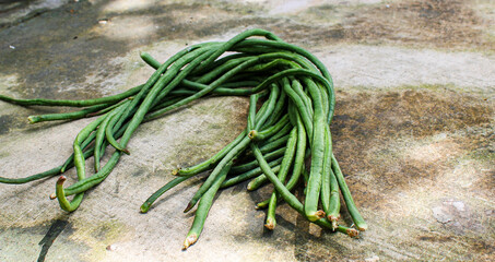 fresh long beans with a rustic floor background