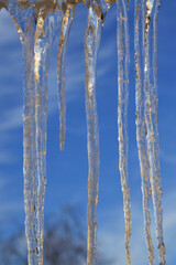 Icicles on sky background.