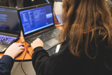 Female software developer students working on computer and laptop, programming contest hackathon...