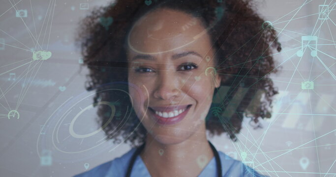 Image of network of connections with icons over biracial woman smiling at camera