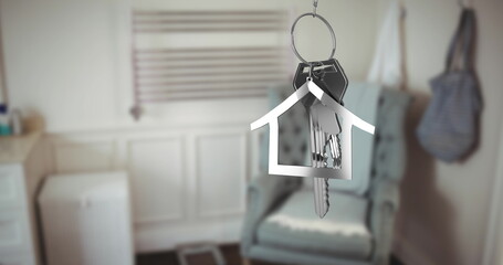 Image of silver key and house key ring over blurred house interior